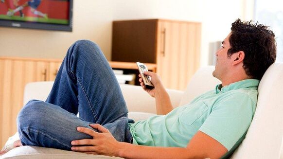 The man is watching TV
